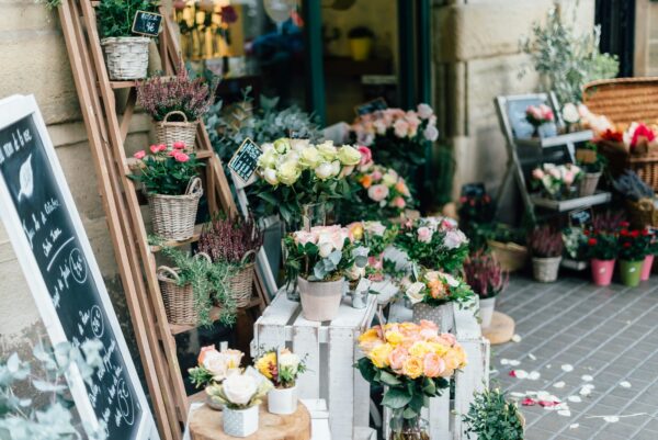 Flower shop with assorted bouquets ready for kraft paper basket bag packaging
