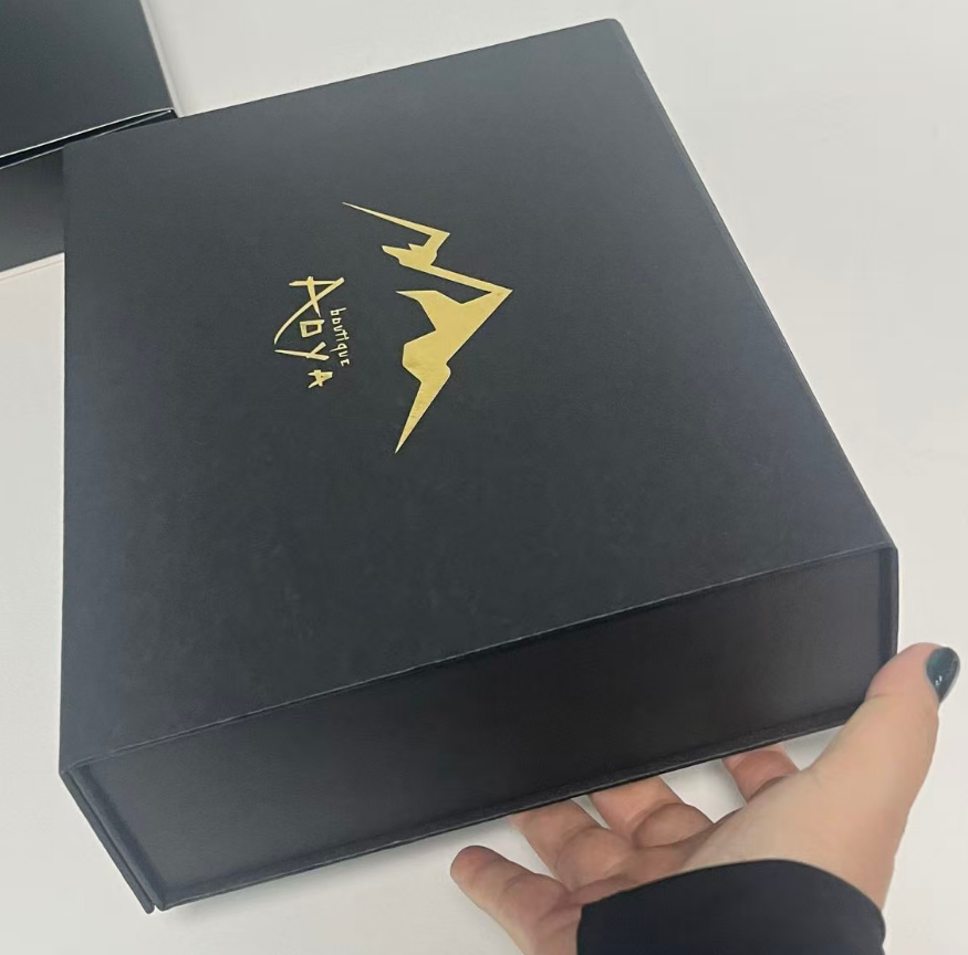 Close-up of gold foil stamped logo on luxury black sushi gift box - custom branded sushi packaging by Holidaypacfactory