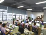 Holidaypacfactory modern office with design team working on custom picnic boxes and food packaging