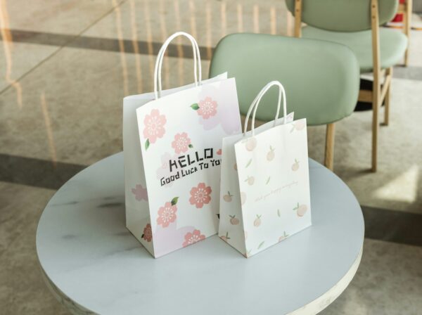Wholesale kraft paper shopping bags on table - Holidaypac eco-friendly packaging