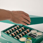Holidaypacfactory green sushi box with built in sauce cup and open meal layout