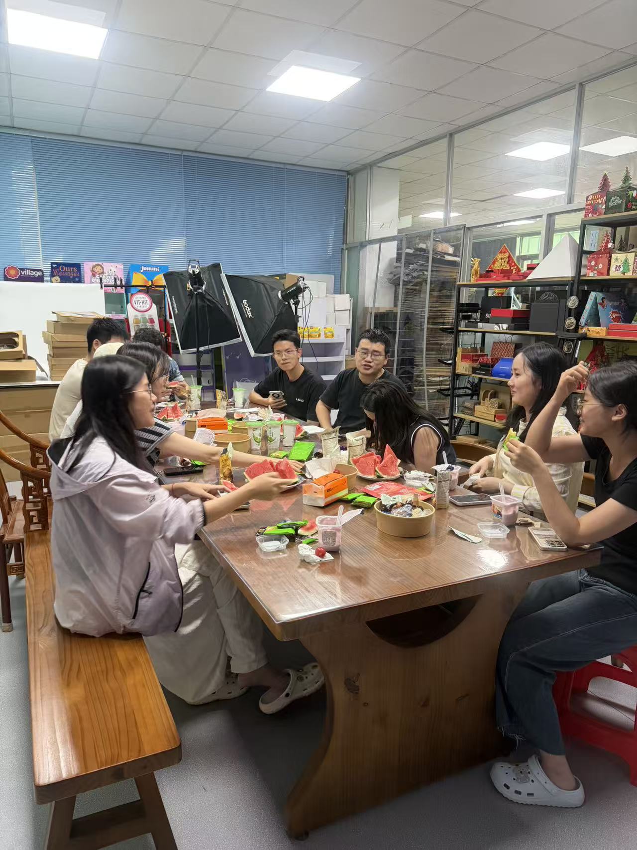 Holidaypac employee tasting festival snacks and watermelon during the Duanwu humanistic culture gathering