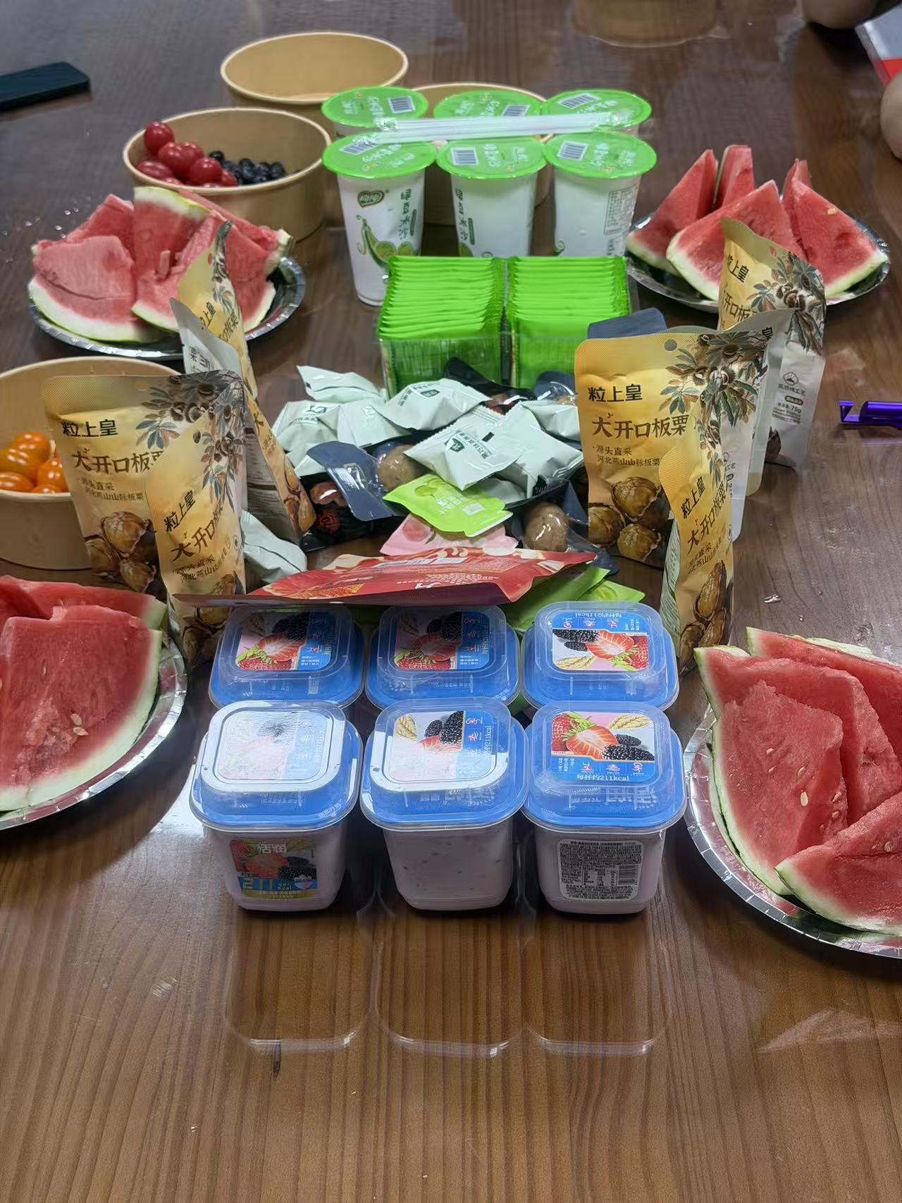 Dragon Boat Festival snack spread at Holidaypac with watermelon, chestnuts, yogurt and fruit on the meeting table