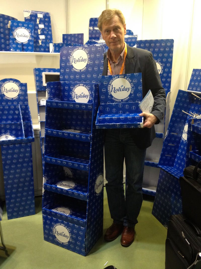 Holidaypacfactory holidaypac factory trade show history customer holding blue cardboard display sample exhibition