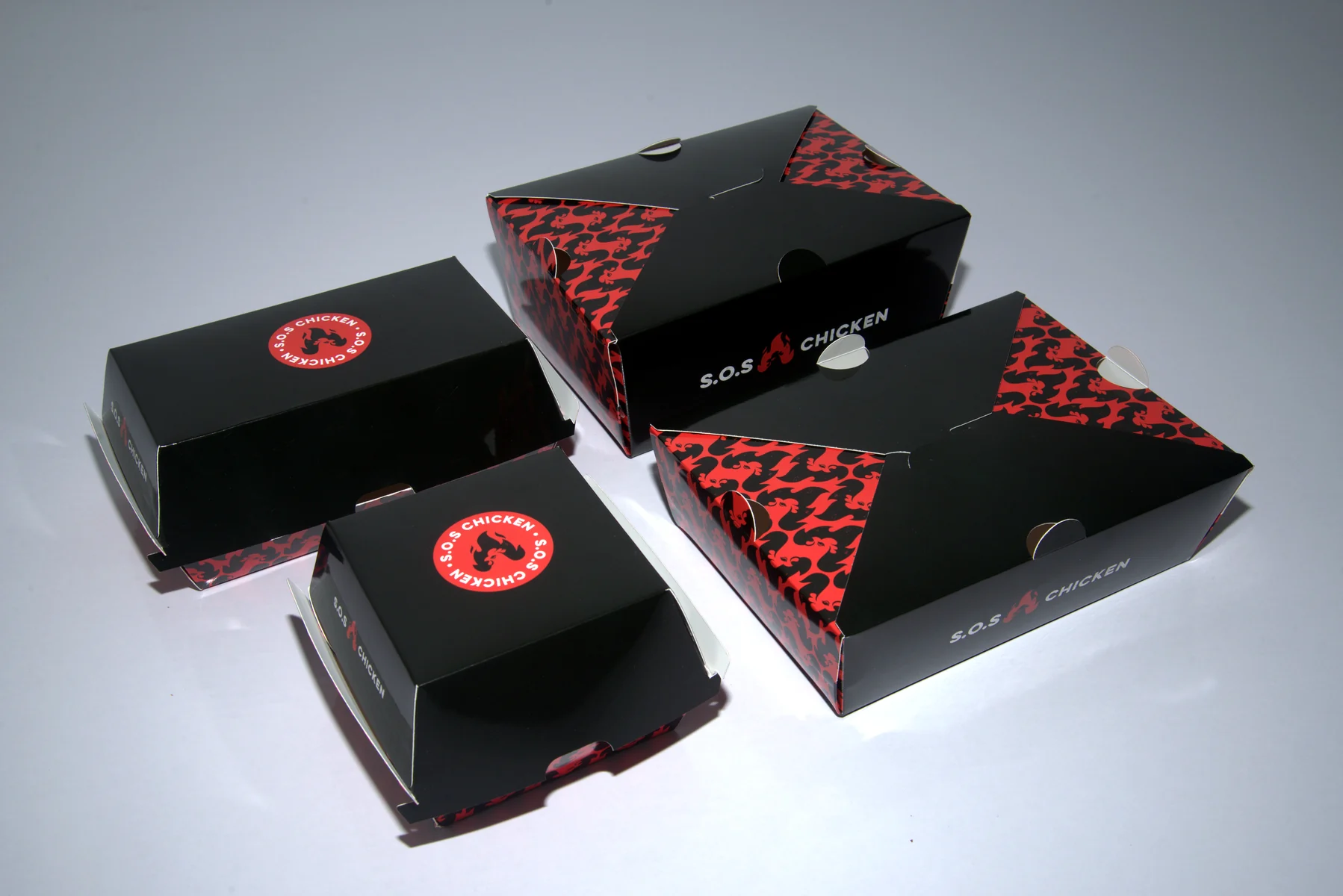 Holidaypacfactory holidaypac factory custom chicken takeaway packaging case study The full set shows how the black-red brand system works across several takeaway box sizes.