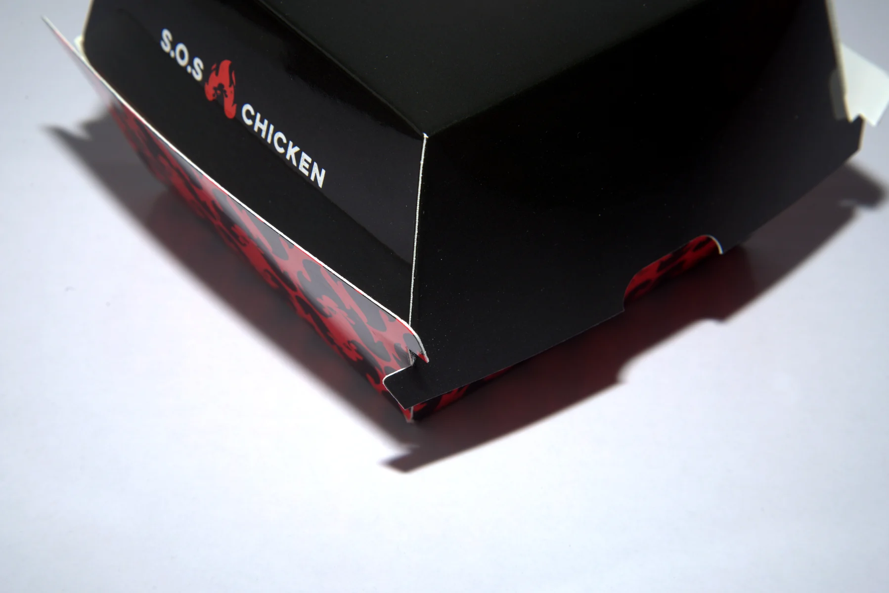 Holidaypacfactory holidaypac factory custom chicken takeaway packaging case study The side detail checks logo placement, closure edge and front-panel brand readability.