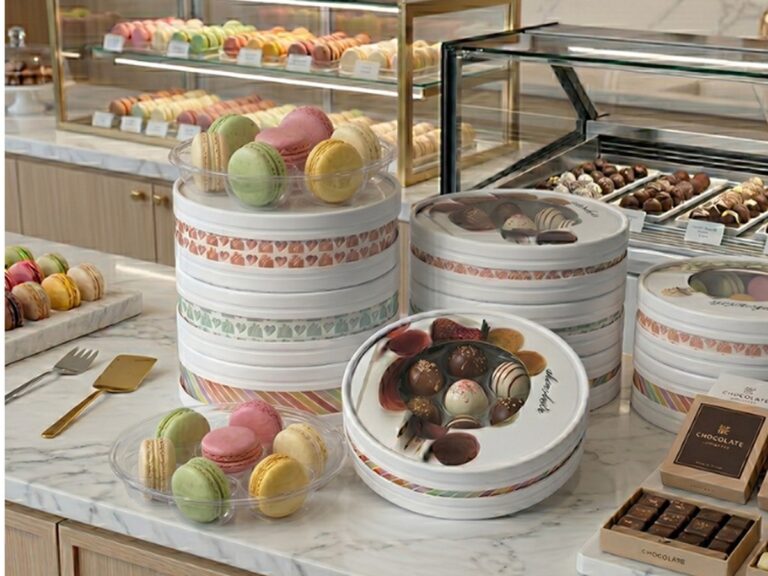 Holidaypacfactory holidaypac factory round paper macaron chocolate box round paper macaron and chocolate box family displayed on a bakery counter