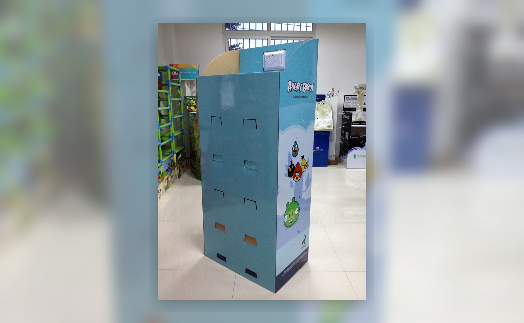 Holidaypacfactory holidaypac factory cardboard display stand with LCD screen back view showing the structural panel, cable access and locking points behind the display.