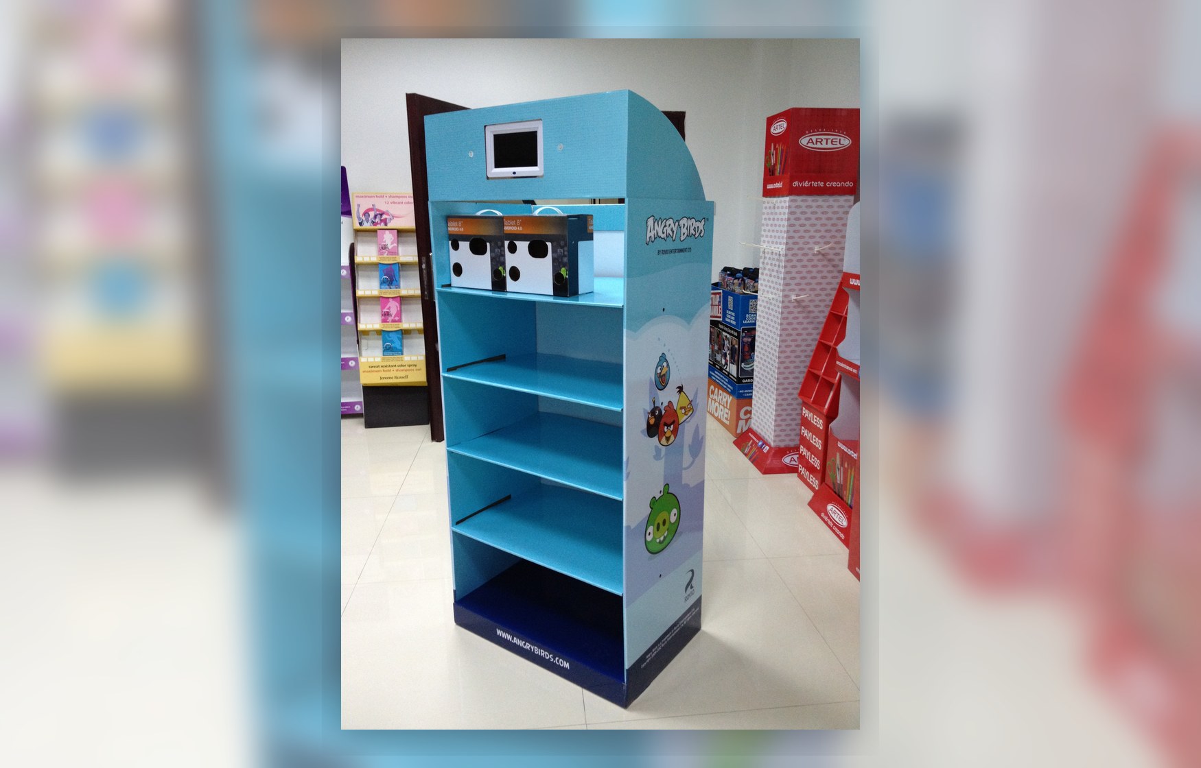 Holidaypacfactory holidaypac factory cardboard display stand with LCD screen retail showroom view showing how the digital header display becomes a full promotional unit.