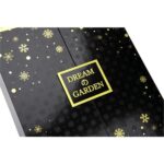 close detail of black perfume packaging with gold snowflake and framed logo artwork Holidaypacfactory