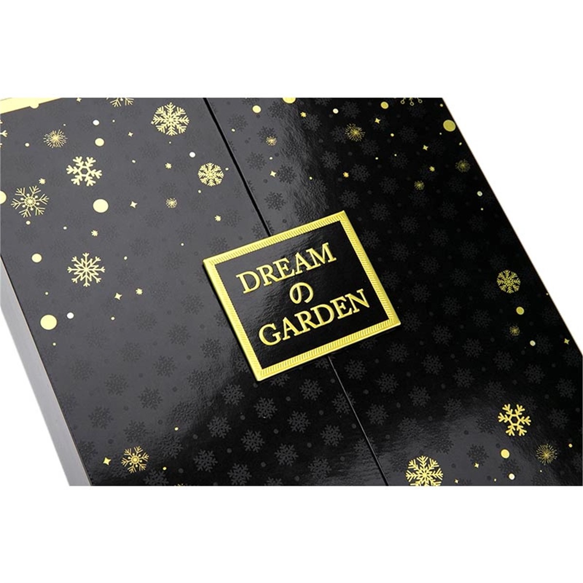 close detail of black perfume packaging with gold snowflake and framed logo artwork Holidaypacfactory