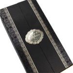 close detail of black perfume packaging box with gold border and patterned wrap Holidaypacfactory