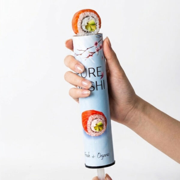 Hand holding sushi push-up paper tube with fresh sushi roll rising from the top