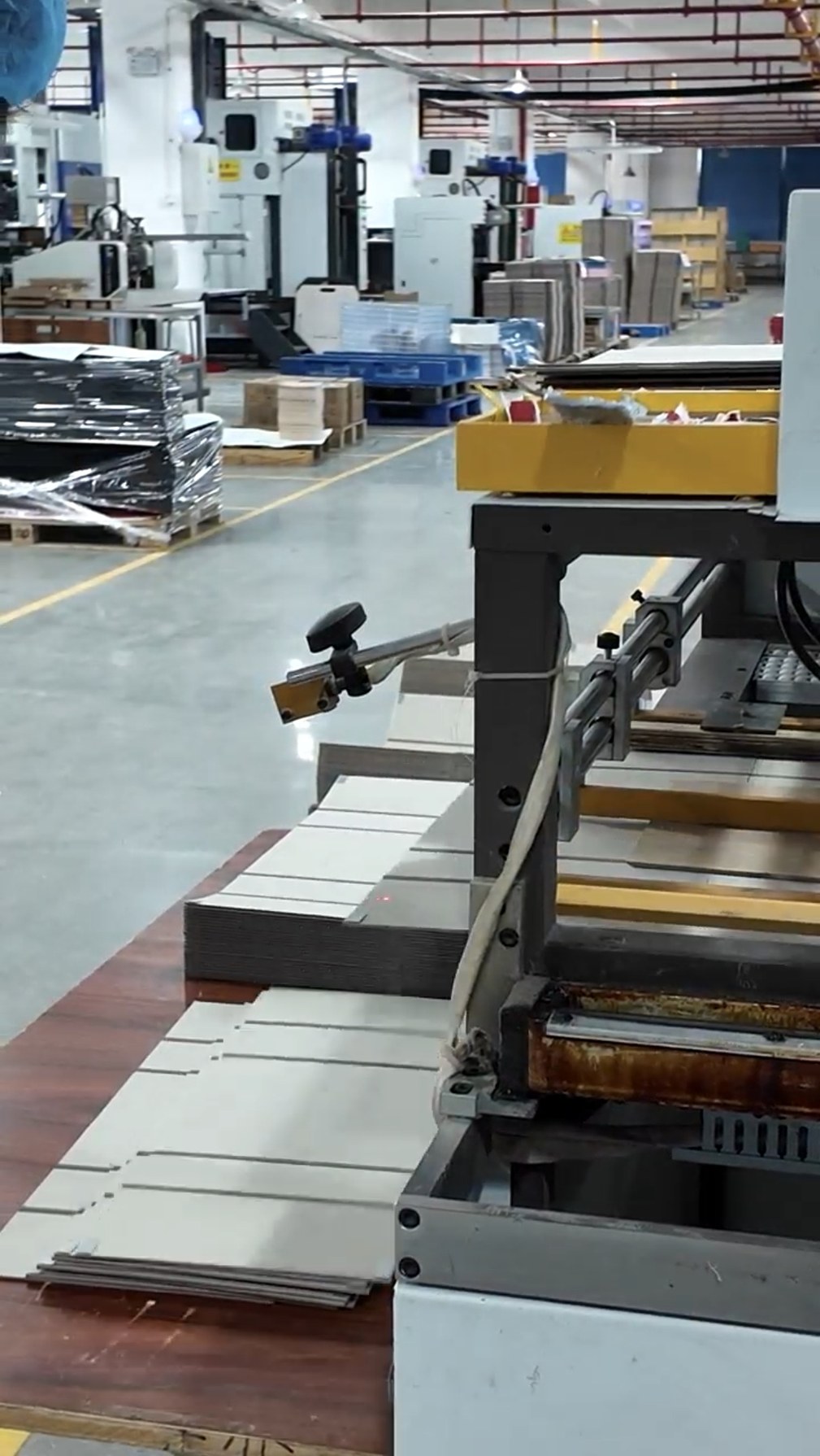 Holidaypacfactory factory floor with packaging machines and stacked materials