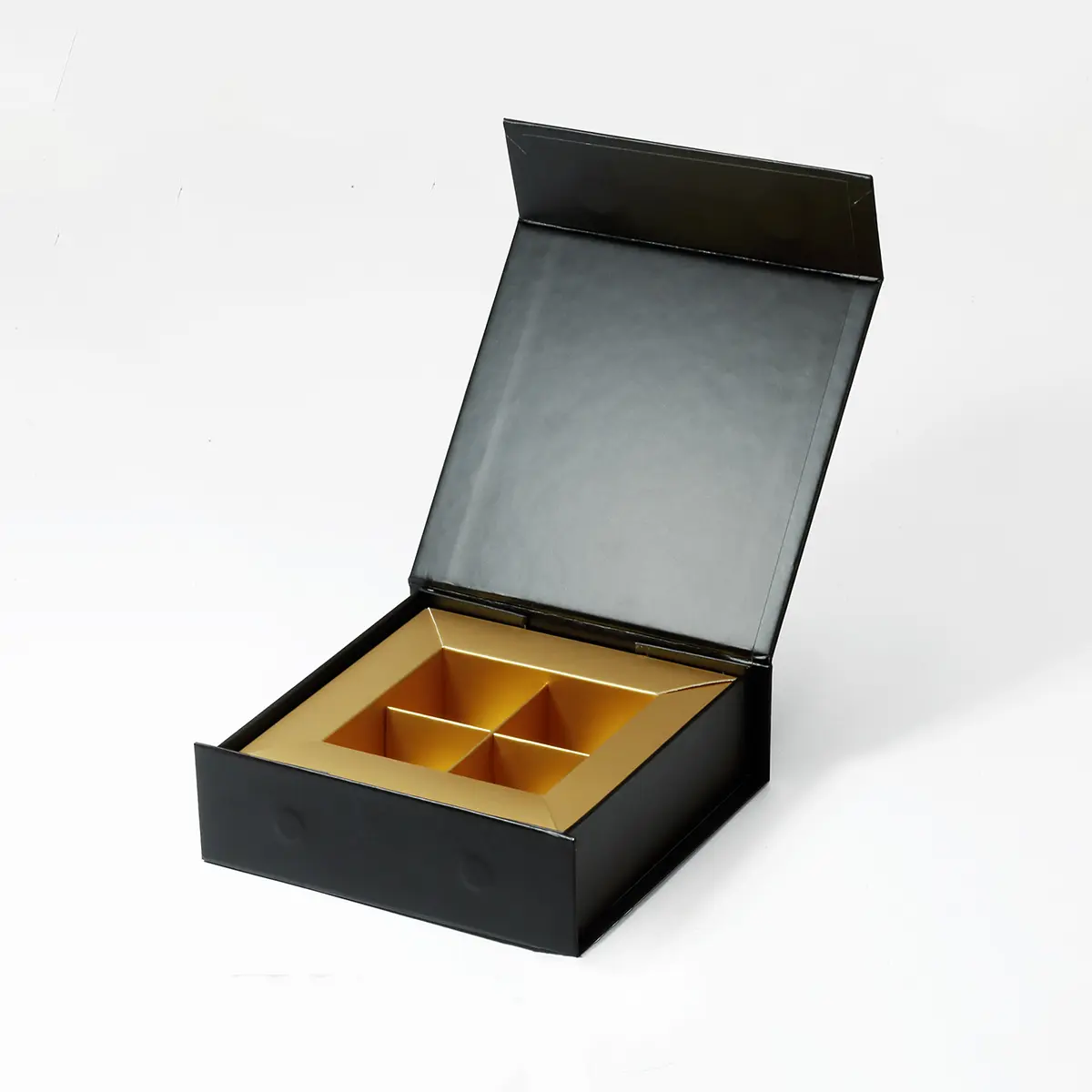 empty four-cavity gold insert inside a black chocolate presentation box Holidaypacfactory